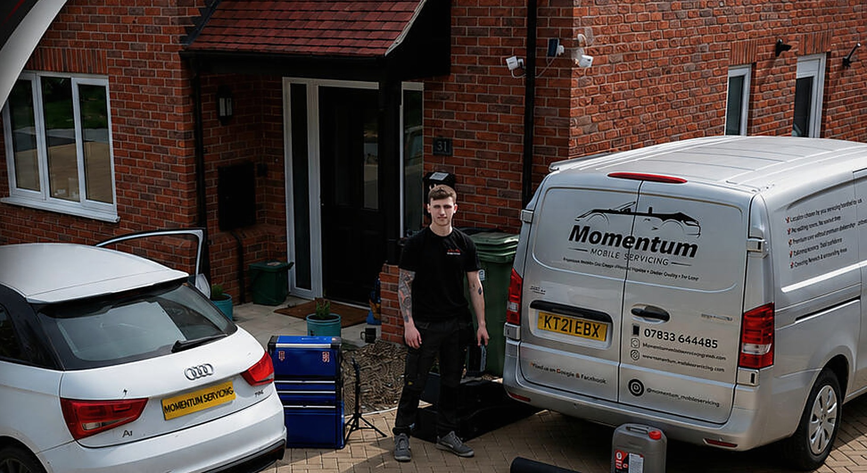 Momentum Mobile Servicing set up on a client’s driveway, with the van and tool chest beside an Audi
